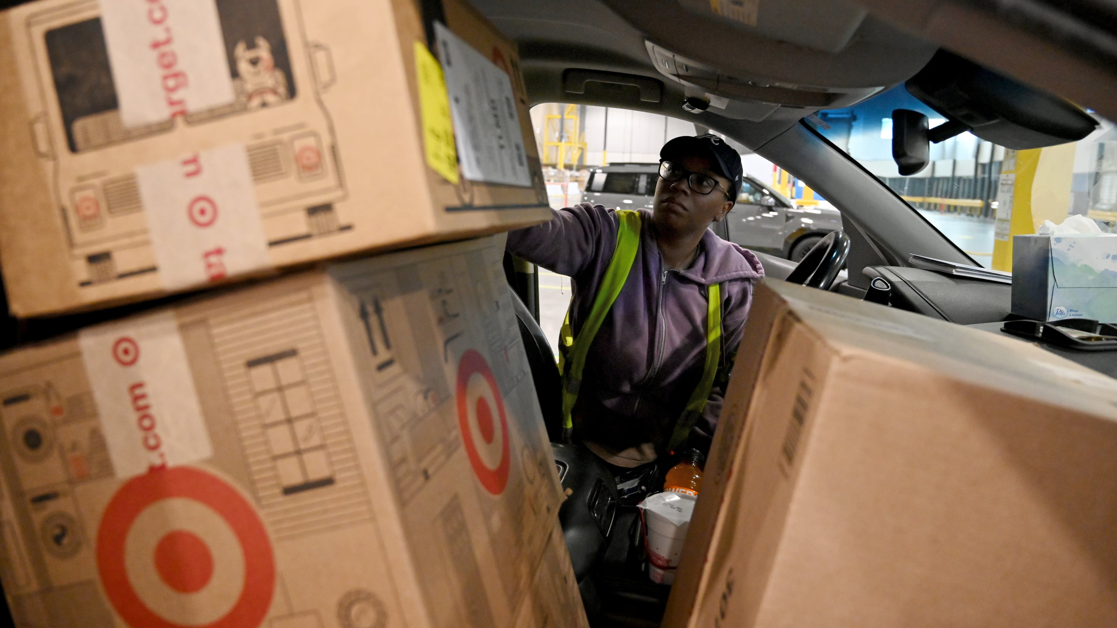 Delivery driver Lonyelle Crocker loads her car with packages at the Target sortation center in Lawrenceville on Friday, Nov. 21, 2025. The center handles the retailer’s online orders within a 90-mile radius. (Hyosub Shin/AJC)