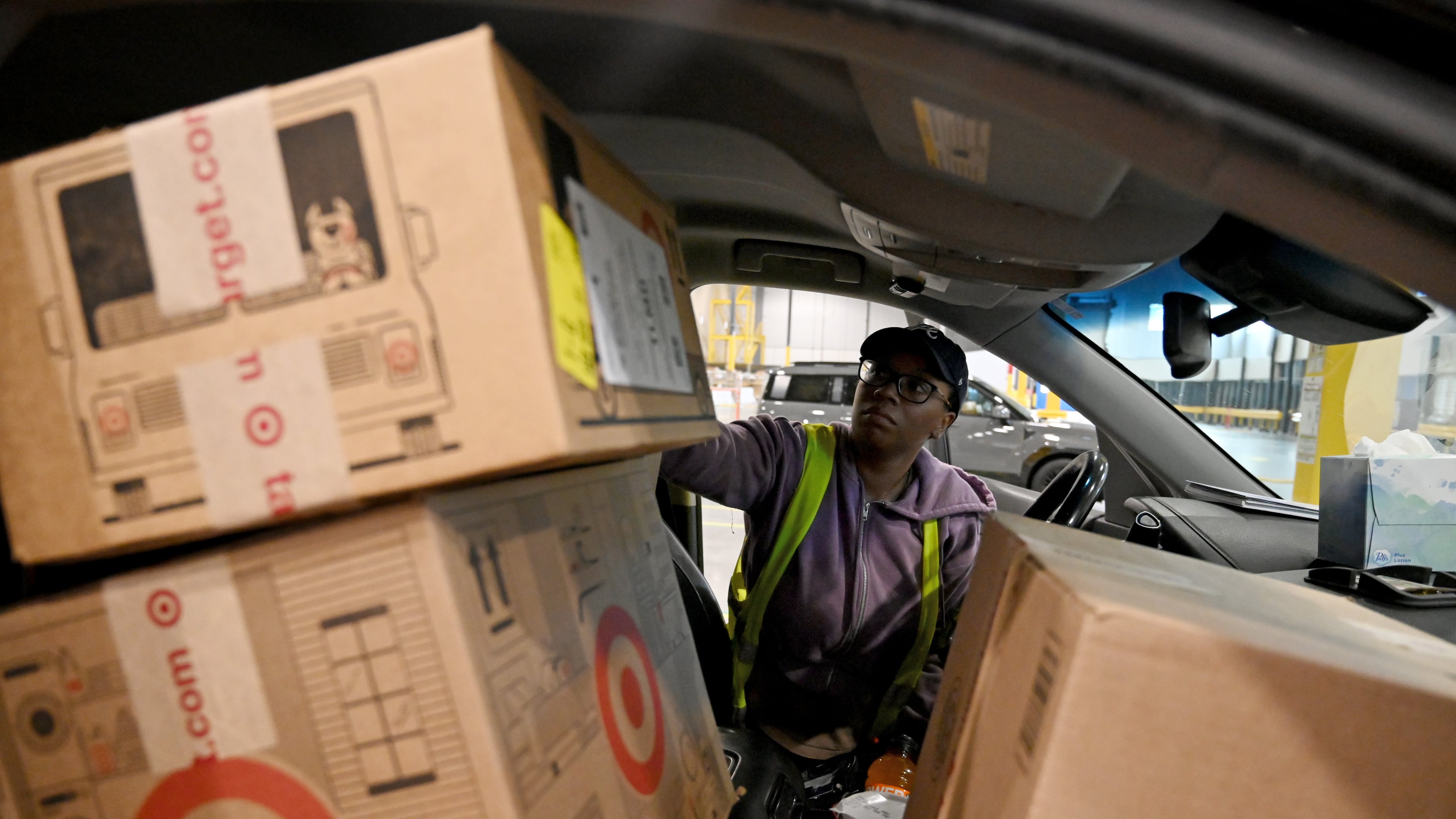 Delivery driver Lonyelle Crocker loads her car with packages at the Target sortation center in Lawrenceville on Friday, Nov. 21, 2025. The center handles the retailer’s online orders within a 90-mile radius. (Hyosub Shin/AJC)