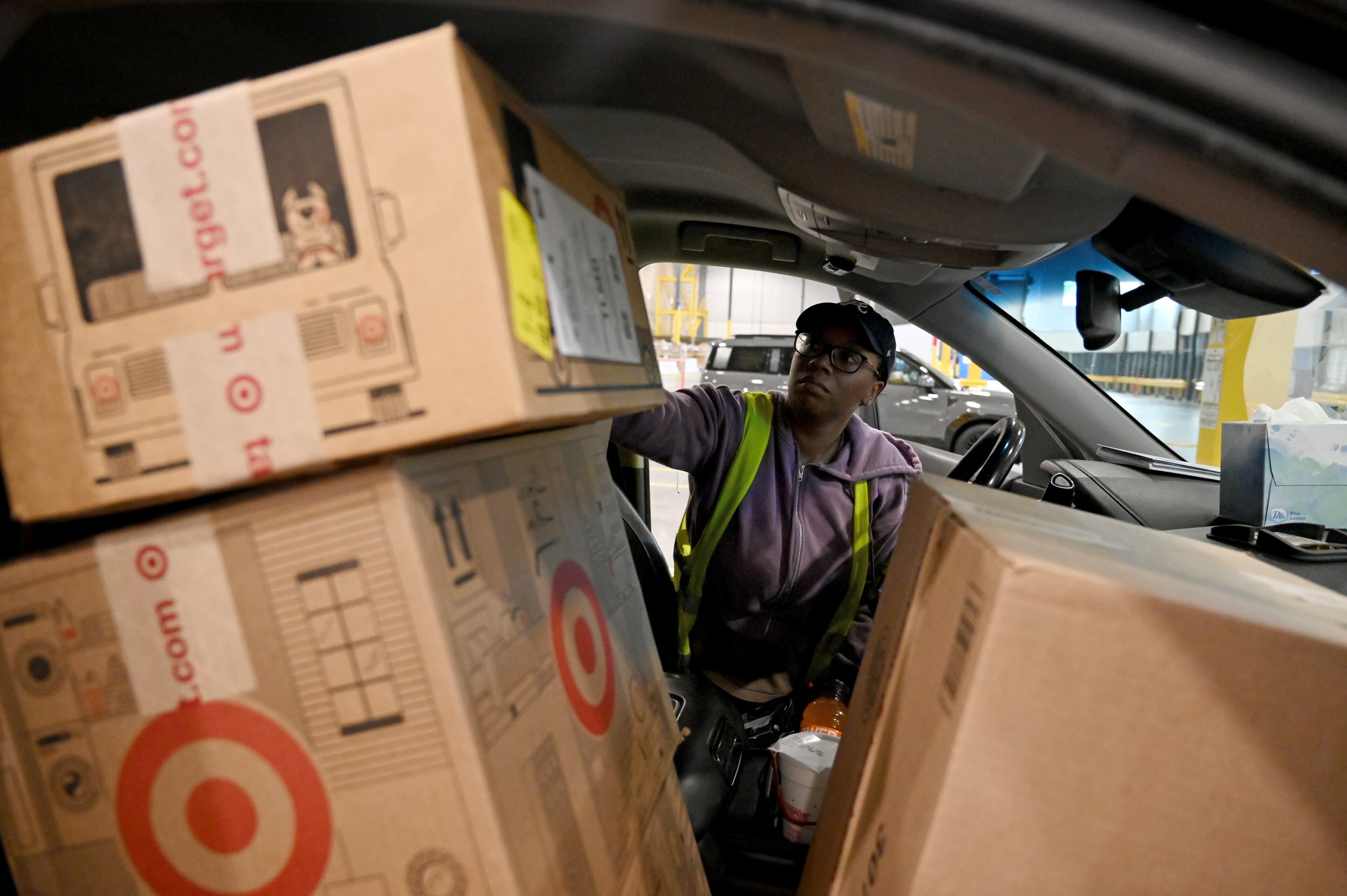 Lonyelle Crocker, delivery driver, is loading her car with packages to deliver at Target sortation center, Friday, November 21, 2025, in Lawrenceville. This is for holiday spending stories. (Hyosub Shin / AJC)