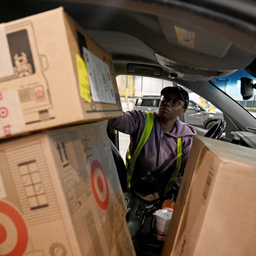 Delivery driver Lonyelle Crocker loads her car with packages at the Target sortation center in Lawrenceville on Friday, Nov. 21, 2025. The center handles the retailer’s online orders within a 90-mile radius. (Hyosub Shin/AJC)