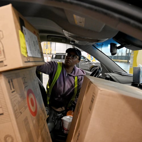 Delivery driver Lonyelle Crocker loads her car with packages at the Target sortation center in Lawrenceville on Friday, Nov. 21, 2025. The center handles the retailer’s online orders within a 90-mile radius. (Hyosub Shin/AJC)