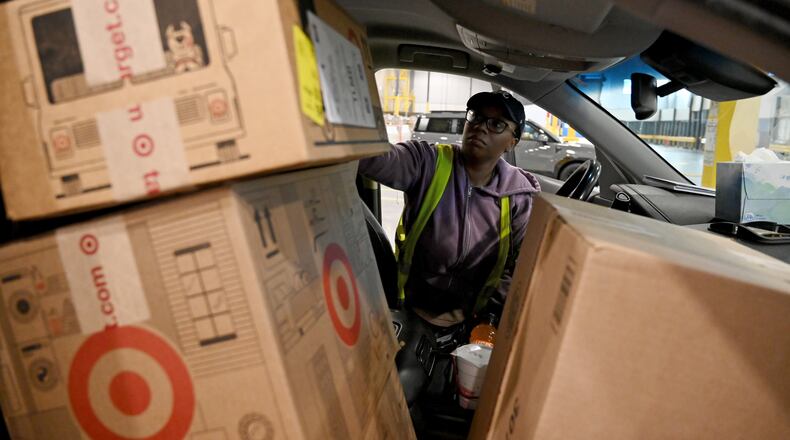 Delivery driver Lonyelle Crocker loads her car with packages at the Target sortation center in Lawrenceville on Friday, Nov. 21, 2025. The center handles the retailer’s online orders within a 90-mile radius. (Hyosub Shin/AJC)