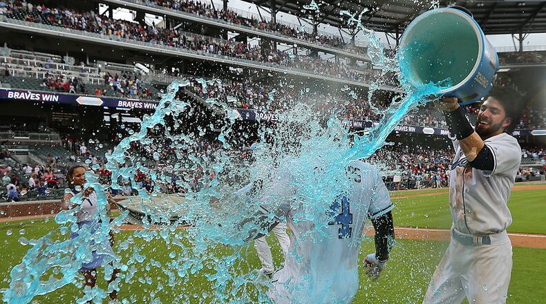 Braves shortstop Dansby Swanson dunks Brandon Phillips after he hit a walk off RBI single to beat the Miami Marlins 5-4 during the 9th inning Sunday, June 18, 2017, in Atlanta.