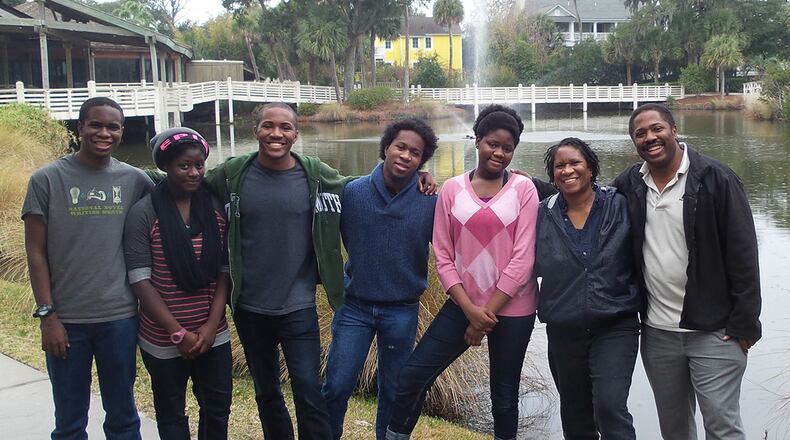 Michelle and Alan Shaw (far right) have three biological sons and adopted twins in 2002. Their children (from left) are: Obasi, Ife, Yesuto, Chinua and Ima.
