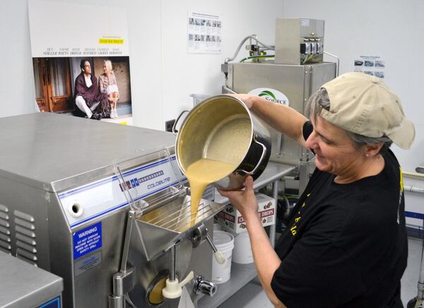 Houdeshell pours the ice cream into the industrial ice cream maker.