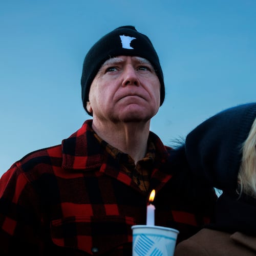 Minnesota Gov. Tim Walz and his wife, Gwen Walz, attend a vigil honoring Renee Good on Friday, Jan. 9, 2026, in St. Paul, Minn., outside the Minnesota State Capitol. (Kerem Yücel/Minnesota Public Radio via AP)