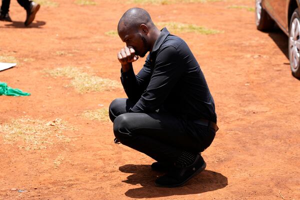 Tauheed Tayo Yakubu, mourns during a funeral ceremony for Nigerian Ladi Anzaki Olubunmi, a TikTok content moderator employed by subcontractor Teleperformance, at the Langata cemetery in Nairobi, Kenya Thursday, April. 17, 2025. (AP Photo/Brian Inganga)