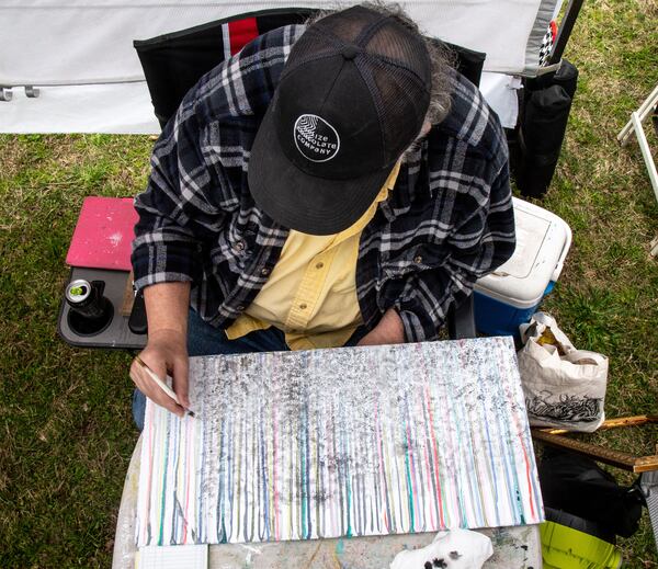 Stan Brans works on one of his paintings in his artist tent during Festival on Ponce’s spring event in April.  