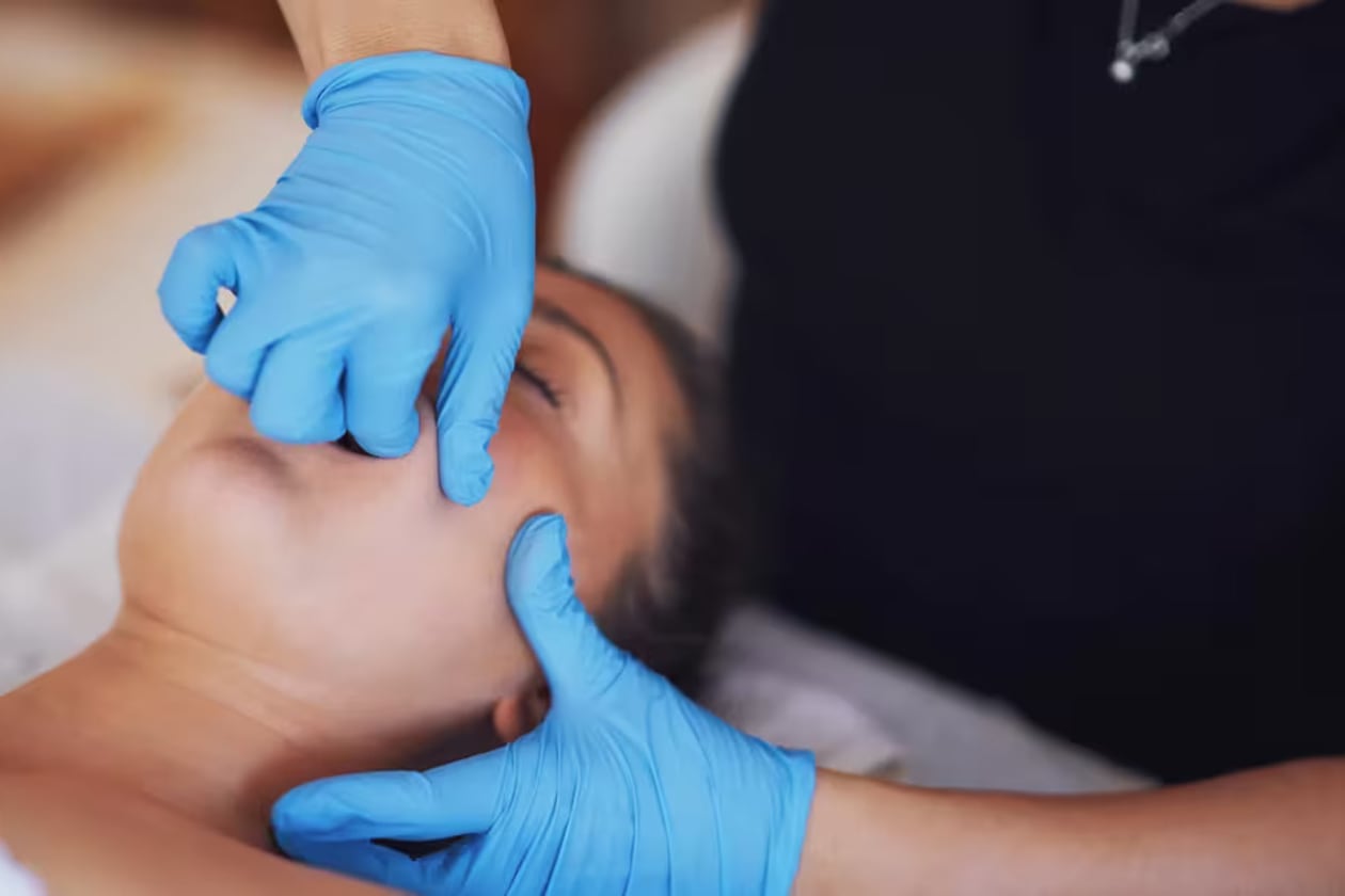 Intense intra-oral treatment, known as TMJ therapy, is when a practitioner works inside the mouth to release pain and tension in the jaw muscle. (Courtesy of Cleveland Clinic)
