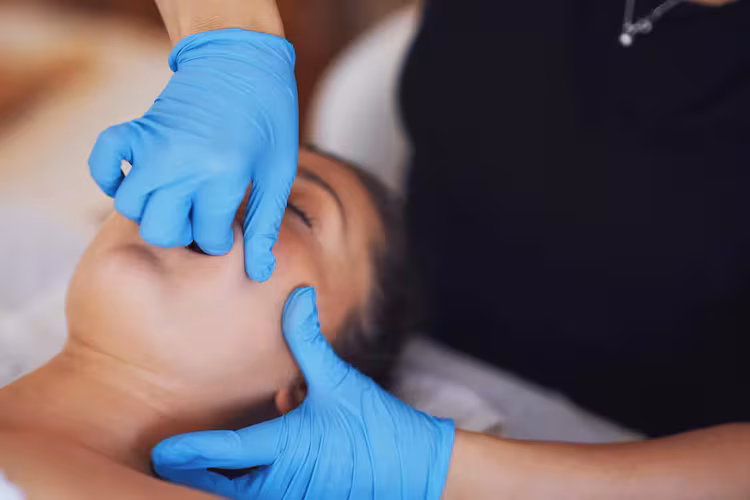 Intense intra-oral treatment, known as TMJ therapy, is when a practitioner works inside the mouth to release pain and tension in the jaw muscle. (Courtesy of Cleveland Clinic)