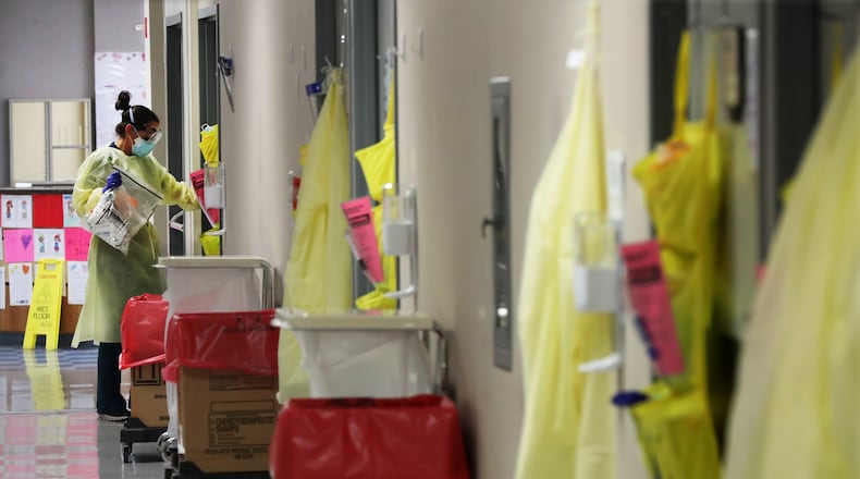 Ceri West, a registered nurse, enters one of the monoclonal antibody infusion rooms to help treat patients with COVID-19 at Phoebe Putney Memorial Hospital (North Campus) on Monday. Curtis Compton / Curtis.Compton@ajc.com”