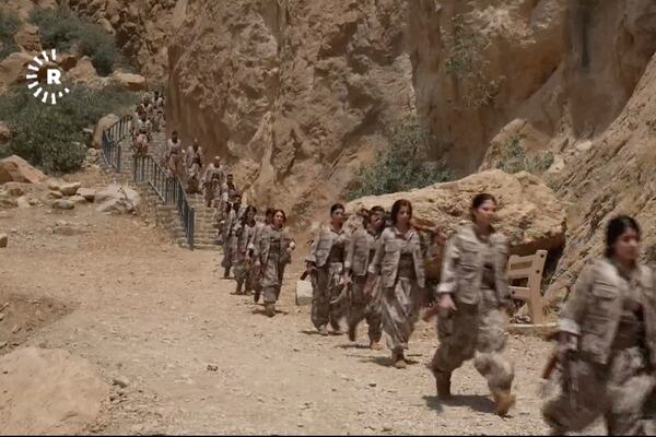 This frame grab from a video released by Rudaw TV shows PPK ( Kurdistan Workers' Party ) fighters arriving for a symbolic disarmament ceremony as part of the peace process with Turkey, in Sulaymaniyah governorate, Iraq's semi-autonomous Kurdish region, Friday, July 11, 2025. ( Rudaw TV via AP)