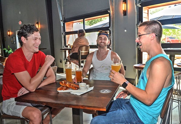Alex Rhinehart, Eric Laska and Nick Jones enjoy beer and fresh-made Tavern Pretzels at the Lost Druid.