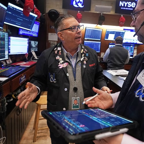 Traders Jonathan Mueller, left, and Michael Capolino confer on the floor of the New York Stock Exchange, Thursday, April 23, 2026. (AP Photo/Richard Drew)