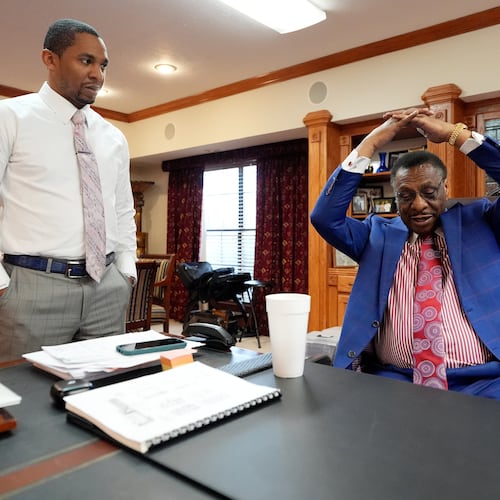 Attorney Edward Blackmon Jr., 78, a civil rights attorney and a former state representative, right, demonstrates how he and other civil rights marchers were taught how to protect themselves if physically set upon by lawmen to his son State Sen. Bradford Blackmon, D-Canton, in Canton, Miss., Friday, May 1, 2026. (AP Photo/Rogelio V. Solis)