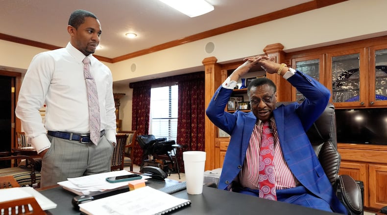 Attorney Edward Blackmon Jr., 78, a civil rights attorney and a former state representative, right, demonstrates how he and other civil rights marchers were taught how to protect themselves if physically set upon by lawmen to his son State Sen. Bradford Blackmon, D-Canton, in Canton, Miss., Friday, May 1, 2026. (AP Photo/Rogelio V. Solis)