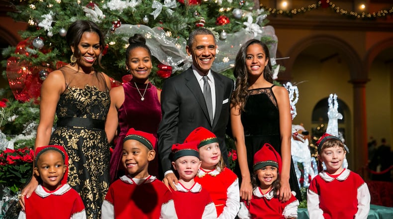 President Barack Obama, center right, first lady Michelle Obama, left, and daughters Sasha, center left, and Malia, right, pose with 'elves' prior to the taping of TNT's 'Christmas in Washington' program in Washington, D.C. on December 14, 2014. The family released their final White House Christmas cards in 2016. Photo Credit: Kristoffer Tripplaar/ Sipa USA (Photo by SIPA USA-KT/SIPA/WHITE HOUSE POOL (ISP POOL IMAGES)/Corbis/VCG via Getty Images)