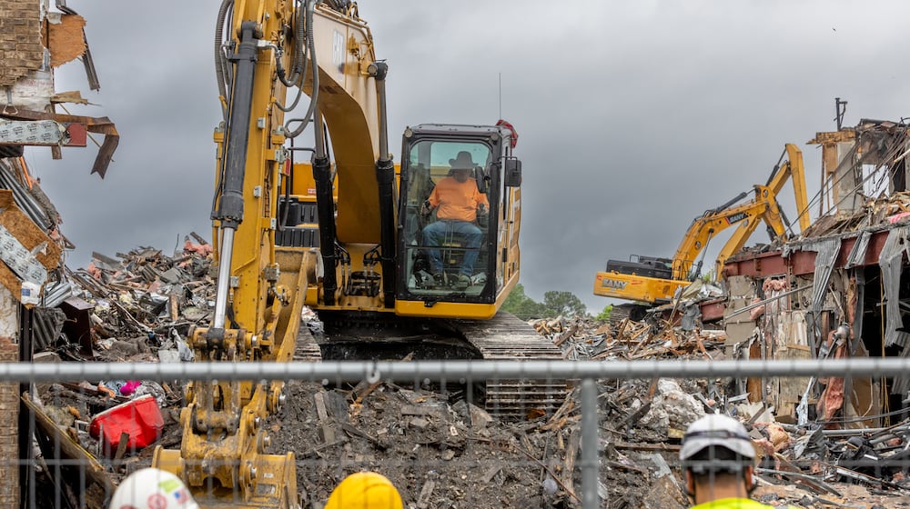Demolition continues on April 11, 2024, at The Reserve at LaVista Walk apartments in northeast Atlanta. Contractors began tearing down the crumbling building that went up in flames in November 2023. (John Spink/AJC)