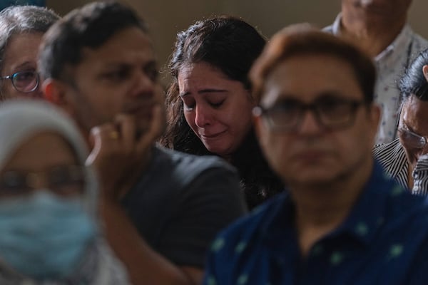 A relative of the crew of the Air India flight that crashed in Ahmedabad last month, mourns during a prayer meeting at a church in Mumbai, India, Saturday, July 12, 2025. (AP Photo/ Rafiq Maqbool)