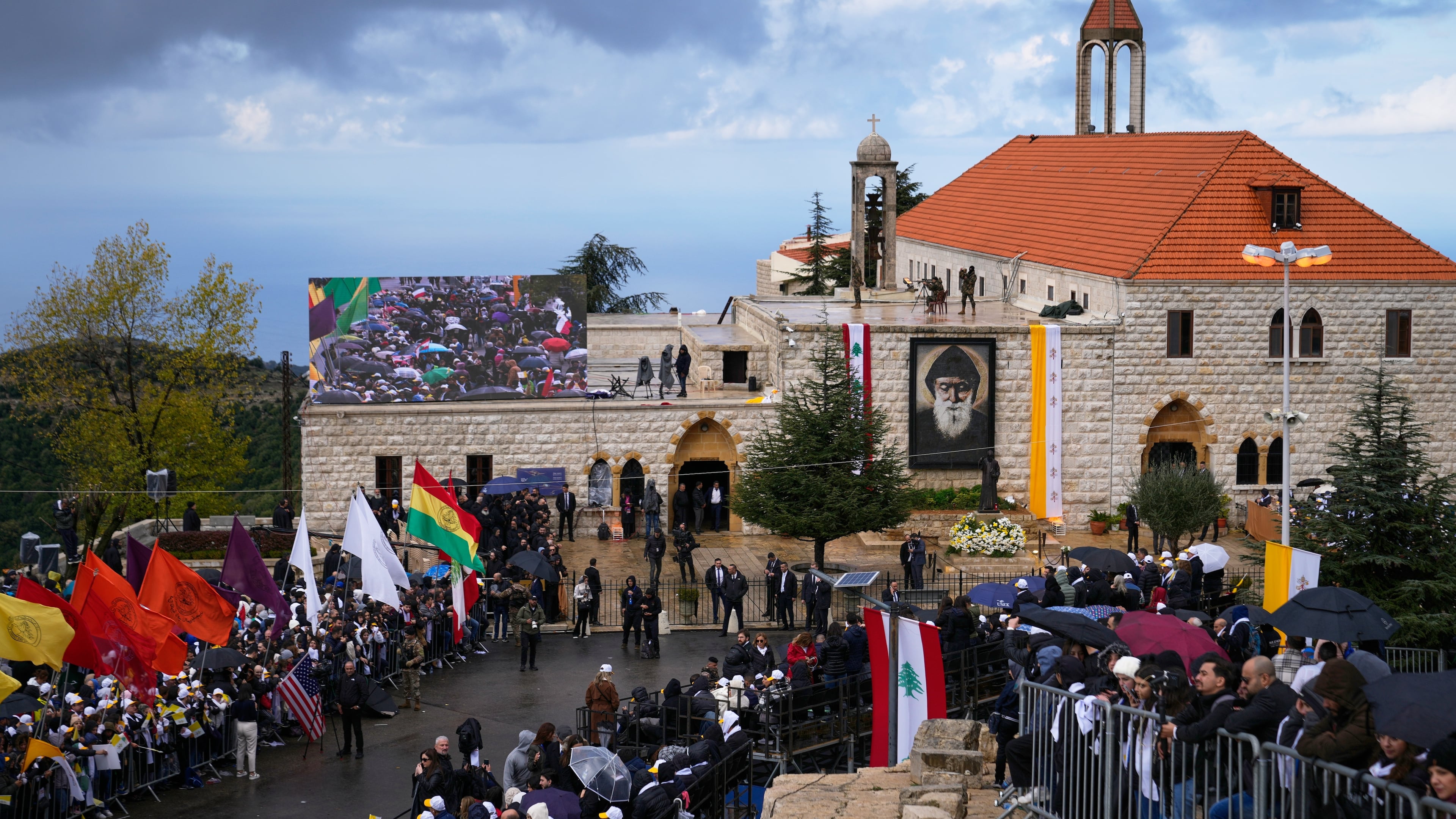 People wait outside the Monastery of Saint Maron ahead of Pope Leo XIV's arrival in Annaya, Lebanon, Monday, Dec. 1, 2025. (AP Photo/Hassan Ammar)