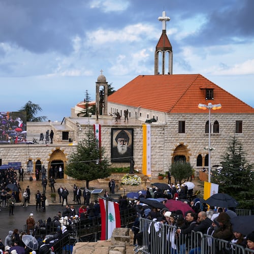 People wait outside the Monastery of Saint Maron ahead of Pope Leo XIV's arrival in Annaya, Lebanon, Monday, Dec. 1, 2025. (AP Photo/Hassan Ammar)