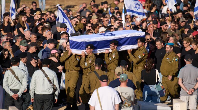 Israeli soldiers carry the casket of Staff sergeant Noam Hamburger, who was killed in a Lebanese drone attack on northern Israel, during his funeral in Atlit, Israel, Sunday, May 24, 2026. (AP Photo/Ariel Schalit)