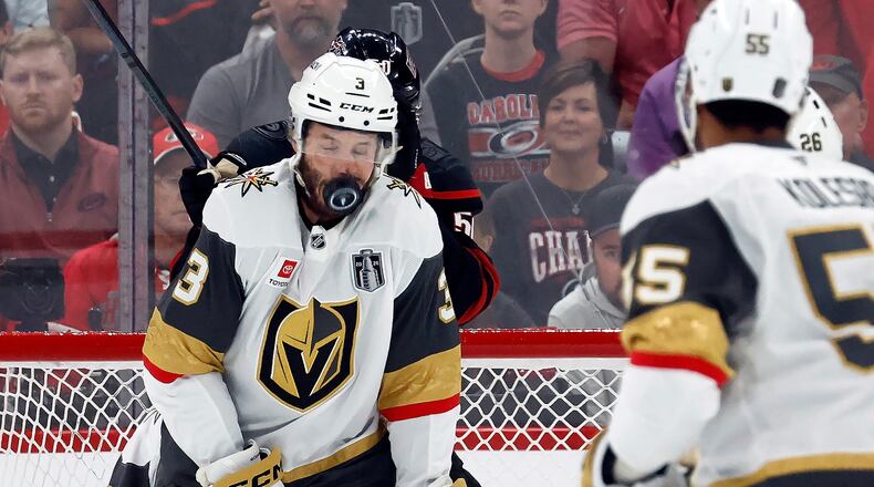 Vegas Golden Knights' Brayden McNabb takes a puck to the face during the first period in Game 2 of the NHL hockey Stanley Cup Final series against the Carolina Hurricanes in Raleigh, N.C., Thursday, June 4, 2026. (AP Photo/Karl DeBlaker)