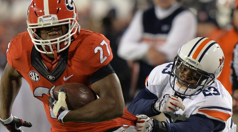 November 15, 2014 Athens, GA:Auburn Tigers defensive back Johnathan Ford tries to pull down Georgia Bulldogs running back Nick Chubb by his shirt tail during the second half Saturday November 15, 2014. BRANT SANDERLIN / BSANDERLIN@AJC.COM