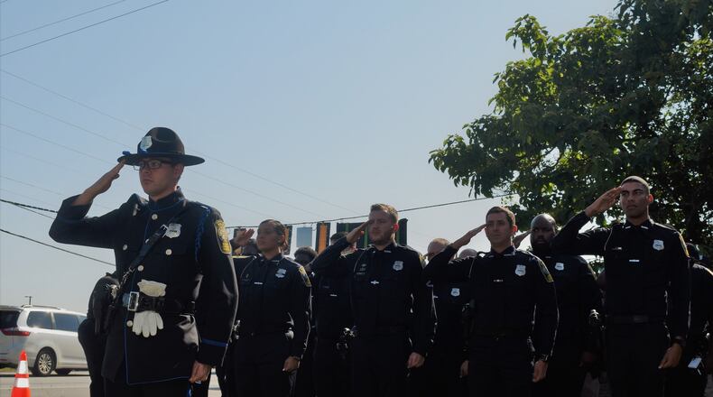 Officers honor their fallen comrade at the highway naming ceremony.