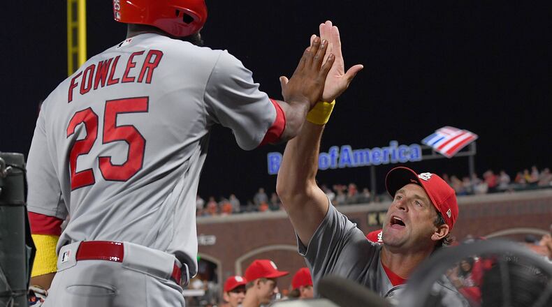 Dexter Fowler of the St. Louis Cardinals is congratulated by manager Mike Matheny scoring against the San Francisco Giants in the top of the ninth inning at AT&T Park on Sept. 1, 2017.