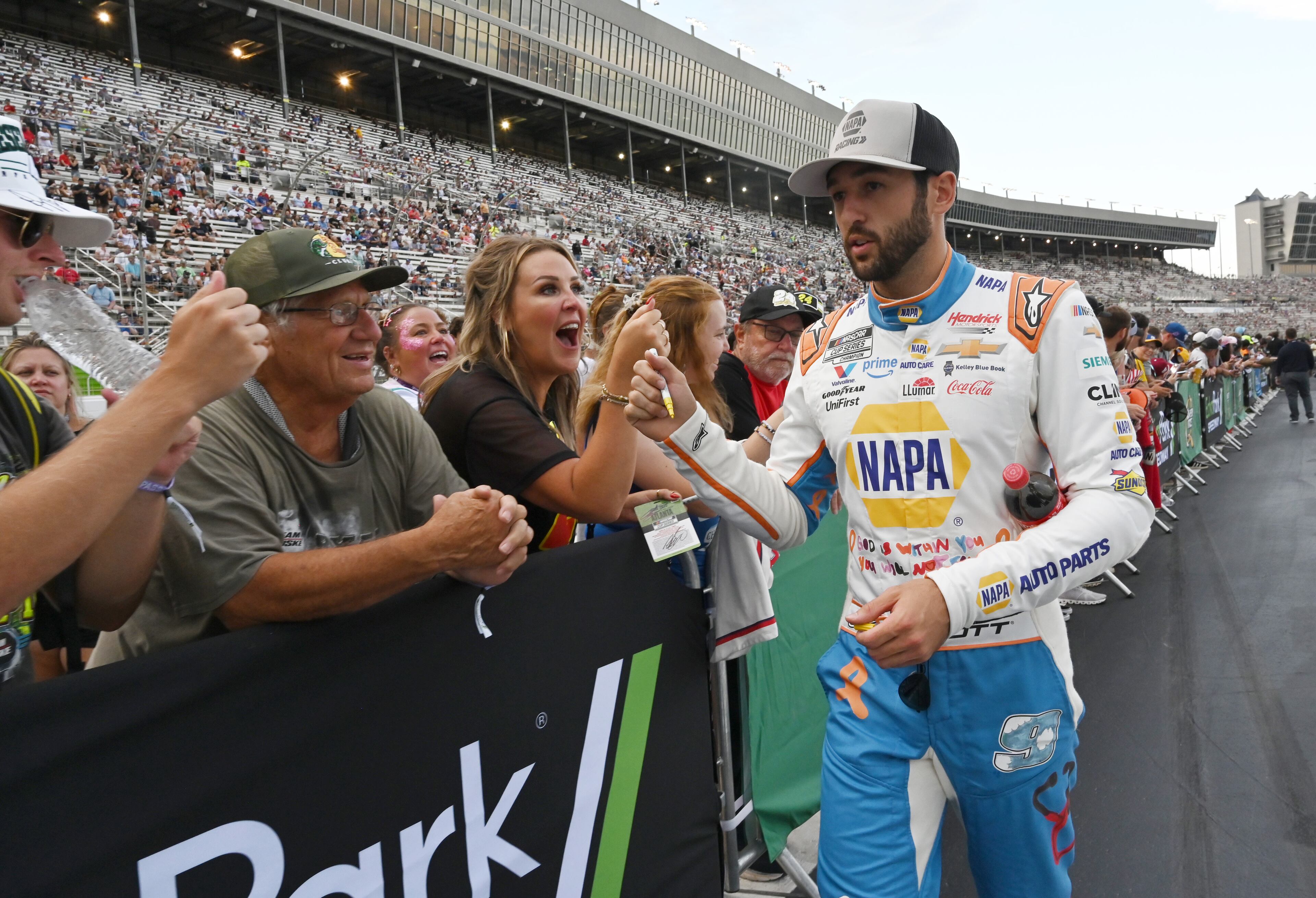 NASCAR Cup Series driver Chase Elliott is greeted by fans before Quaker State 400 NASCAR Cup Series race at EchoPark Speedway, Saturday, June 28, 2025, in Hampton. (Hyosub Shin / AJC)