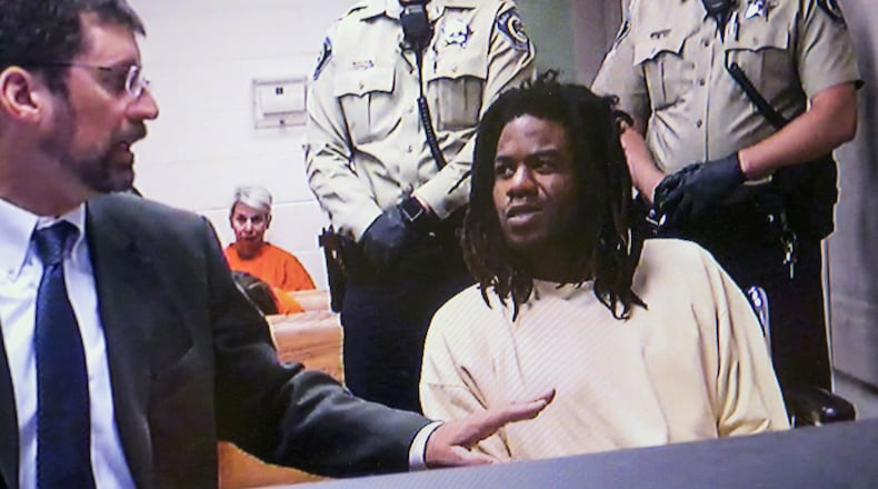Timmy Kinner, right, appears before 4th District Magistrate Judge Russell Comstock in a video arraignment with public defender Dan Dinger, Monday, July 2, 2108, at the Ada County Courthouse in Boise, Idaho. Kinner, 30, is charged with first-degree murder and eight counts of aggravated battery in connection with the stabbing of nine people, six of them children, at a child's birthday party Saturday, June 30. The birthday girl, Ruya Kadir, 3, died of her injuries.