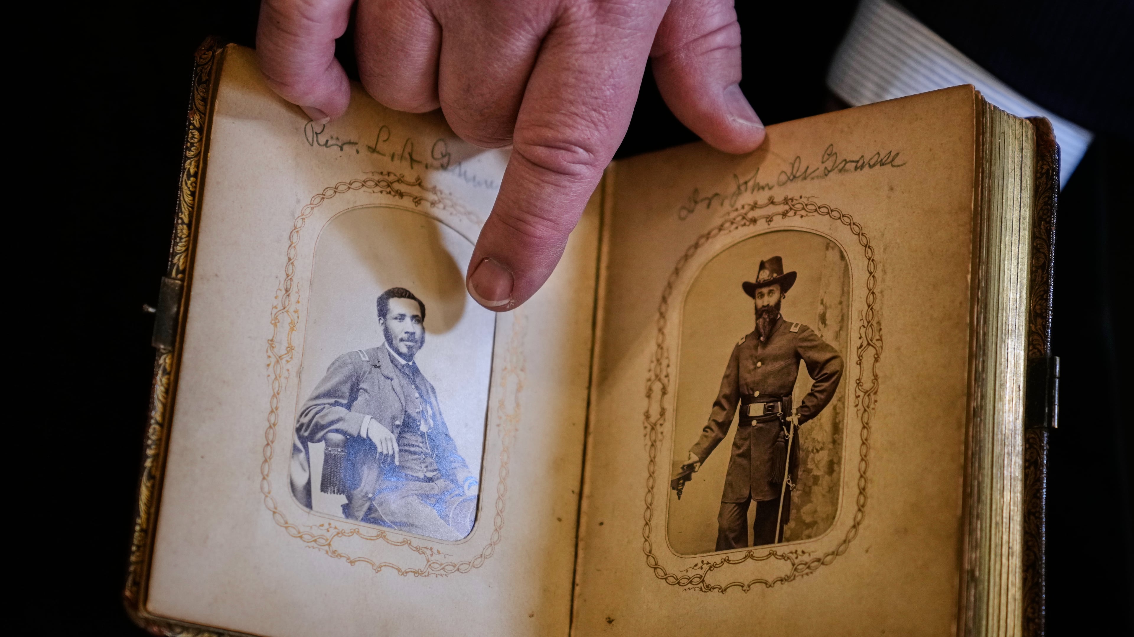 Portraits of Mass. Rep. Charles Lewis Mitchell, left, and Dr. John V. de Grasse are shown from an photograph album from the personal collection of anti-slavery activist Harriet Hayden, which was printed in the 1860's, at the Boston Athenaeum, Thursday, Oct. 9, 2025, in Boston. (AP Photo/Charles Krupa)