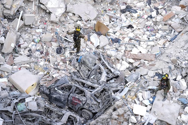 Israeli soldiers search for survivors amid the rubble of residential buildings destroyed by an Iranian missile strike in Bat Yam, central Israel, on Sunday, June 15, 2025. (AP Photo/Ariel Schalit)