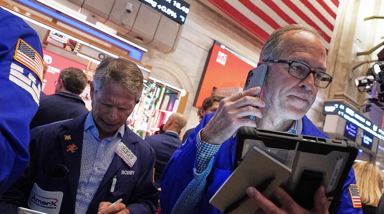 Traders Robert Charmak, left, and Mark Puetzer work on the floor of the New York Stock Exchange, Thursday, June 25, 2026. (AP Photo/Richard Drew)