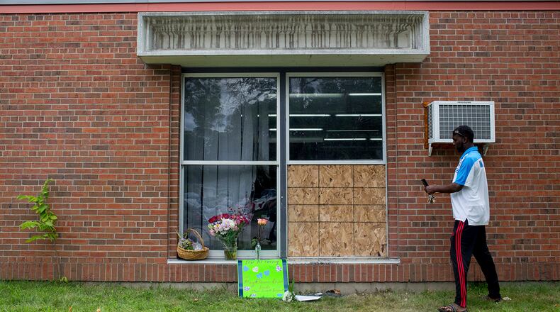 Abdul Mohamed photographs the damage outside of the Dar Al Farooq Islamic Center in Bloomington, Minn., on Sunday, Aug. 6, 2017.  An explosion damaged a room and shattered windows as worshippers prepared for morning prayers early Saturday. (Courtney Pedroza/Star Tribune via AP)