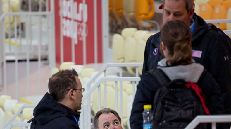 U.S. speedskating team members with president Mike Plant, center, huddle in the stands of the Adler Arena Skating Center after a disappointing start to the 2014 Winter Olympics, Thursday, Feb. 13, 2014, in Sochi, Russia. The U.S. team still has to win its first speedskating medal. (AP Photo/Peter Dejong)