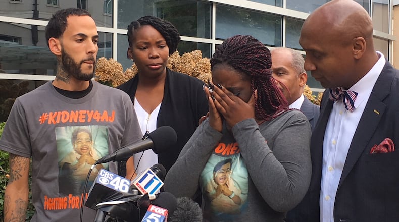 The family of 2-year-old AJ Burgess held a news conference Friday outside Children's Healthcare of Atlanta at Egleston. ELLEN ELDRIDGE / ELLEN.ELDRIDGE@AJC.COM