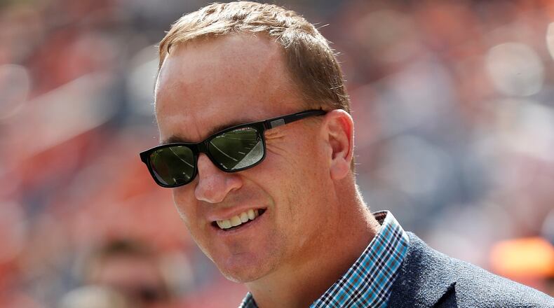 In this Sept. 16, 2018, file photo, former Denver Broncos quarterback Peyton Manning watches prior to an NFL football game against the Oakland Raiders, in Denver. Just as he had the true touch when he threw passes, set records and won two Super Bowls on the field, Peyton Manning possesses the right approach to look back at some of the NFLs greatest moments. Manning, a lock for the Pro Football Hall of Fame when he becomes eligible in 2021, is hosting and serves as one of the executive producers for Peytons Places, a five-part, 30-episode series that celebrates the NFLs 100th season.(AP Photo/Jack Dempsey, File)