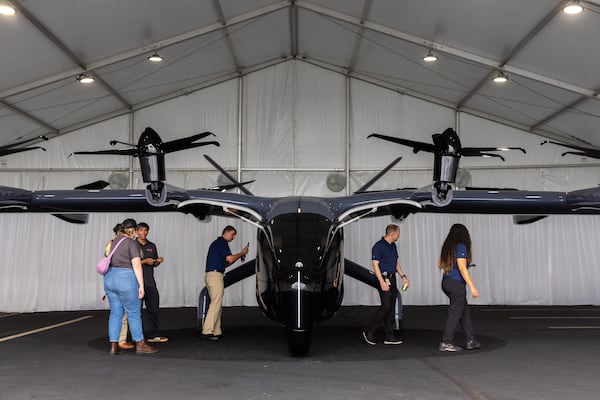 Archer Aviation is an air taxi company with a Georgia manufacturing location. It is a competitor to Delta-backed Joby, which CEO Ed Bastian promises would be able to alleviate the airport commutes of northern Atlanta. People check out Archer’s Midnight electric vertical take-off and landing (eVTOL) aircraft at DeKalb-Peachtree Airport on Thursday, July 25, 2024. (Arvin Temkar/AJC)
