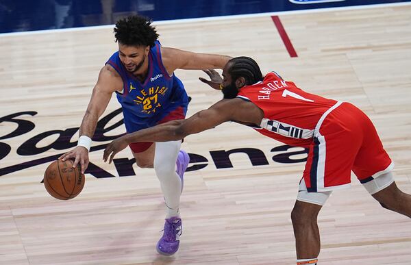 Denver Nuggets guard Jamal Murray, left, drives past Los Angeles Clippers guard James Harden in the first half of Game 1 of an NBA first-round playoff series Saturday, April 19, 2025, in Denver. (AP Photo/David Zalubowski)