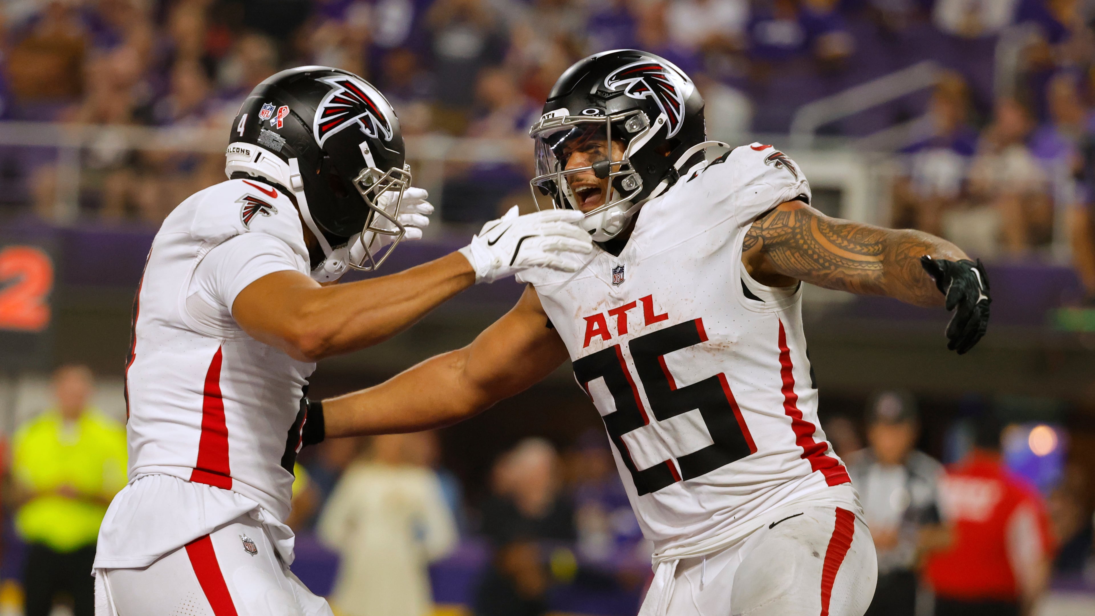 Atlanta Falcons running back Tyler Allgeier (right) celebrates a touchdown during the second half of an NFL football game against the Minnesota Vikings, Sunday, Sept. 14, 2025, in Minneapolis. (Bruce Kluckhohn/AP)