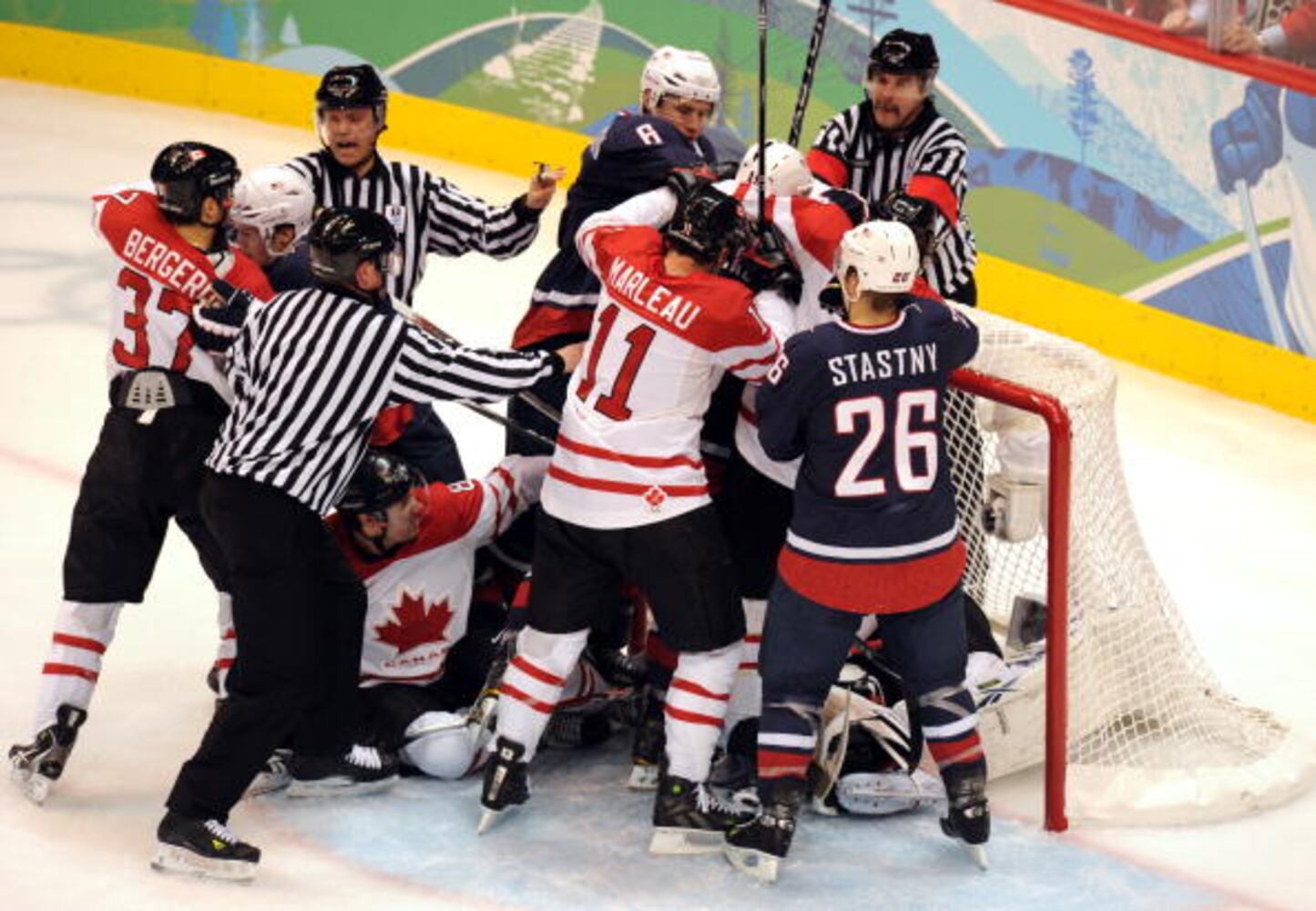 The referees break up a fight during the