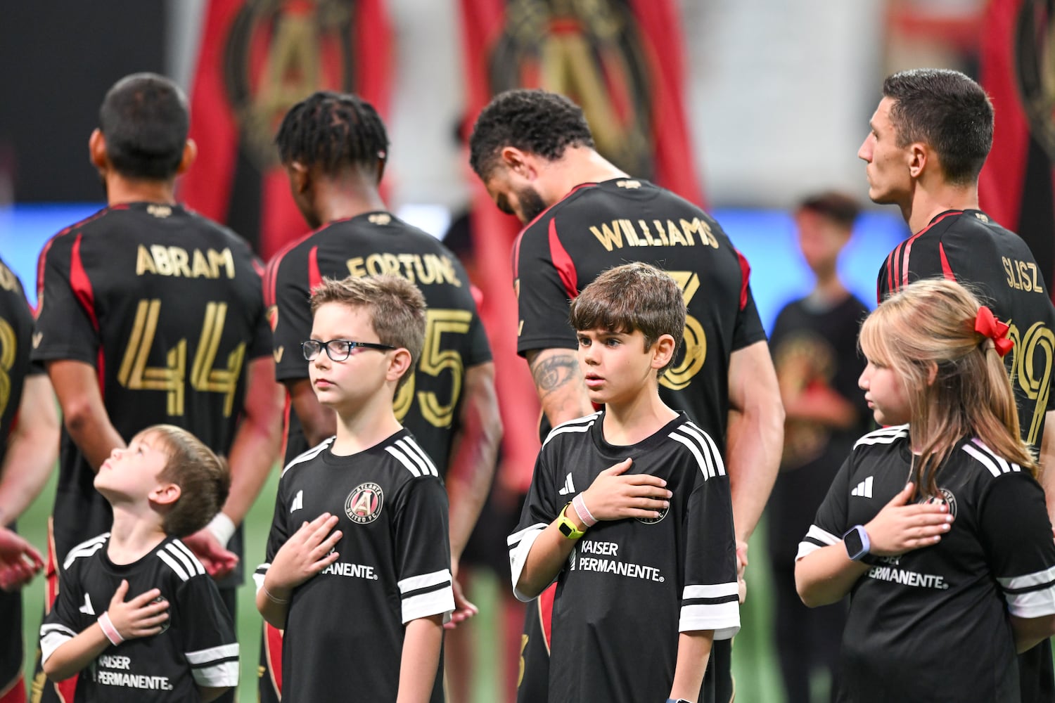 Young players salute during the National Anthem prior to the start of Atlanta United’s game against FC Cincinnati Sunday, May 25, 2025 at the Mercedes-Benz Stadium. (Daniel Varnado/For the Atlanta Journal-Constitution)