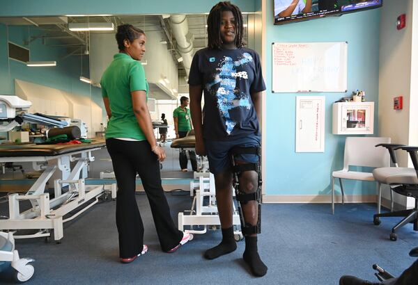 Preston Veal, 12, receives physical therapy from Anzika Tuliva at Children's Healthcare of Atlanta Orthopedics and Sports Medicine, Thursday, July 24, 2025, in Kennesaw.(Hyosub Shin / AJC)