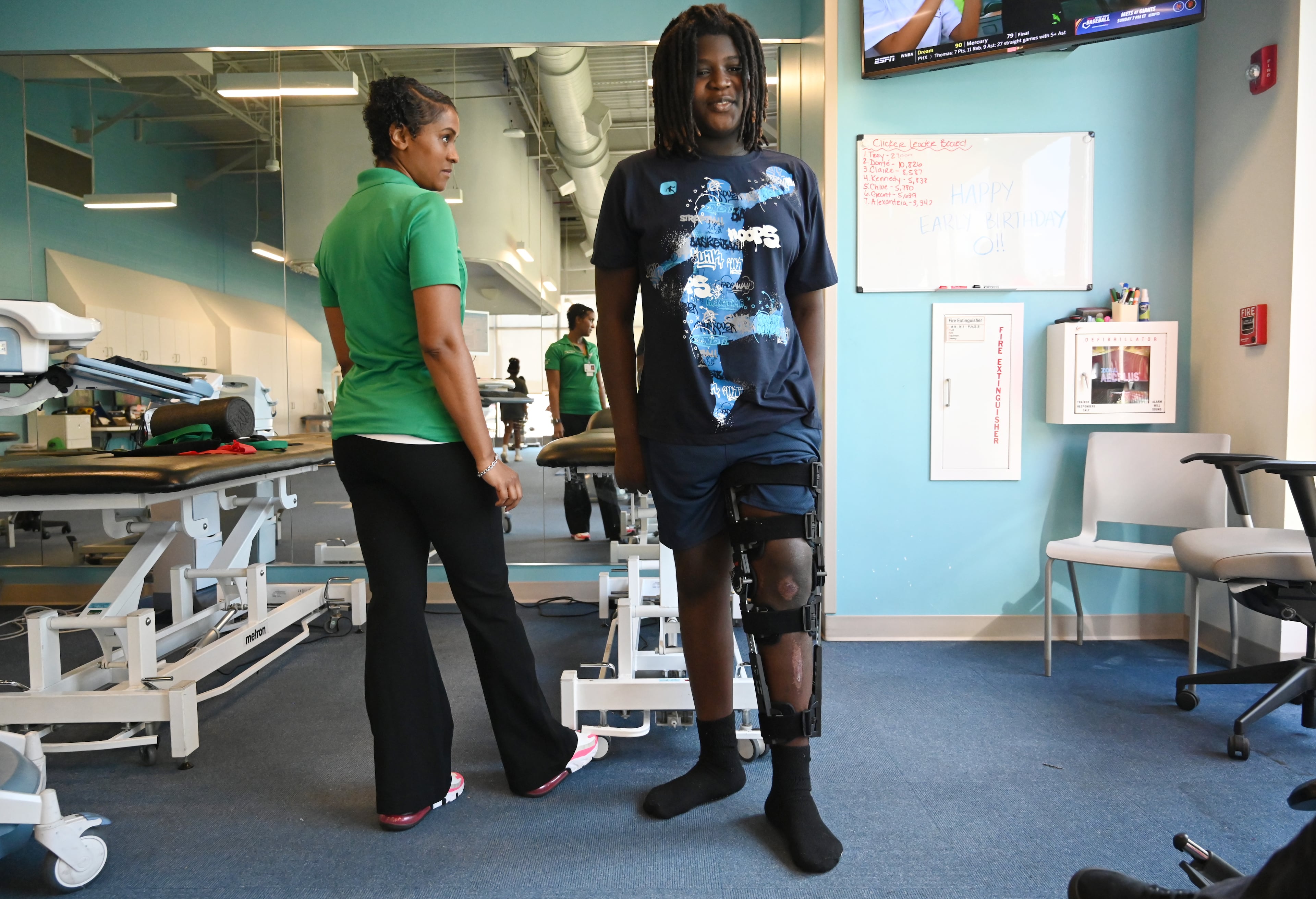 Preston Veal, 12, receives physical therapy from Anzika Tuliva at Children's Healthcare of Atlanta Orthopedics and Sports Medicine, Thursday, July 24, 2025, in Kennesaw.(Hyosub Shin / AJC)