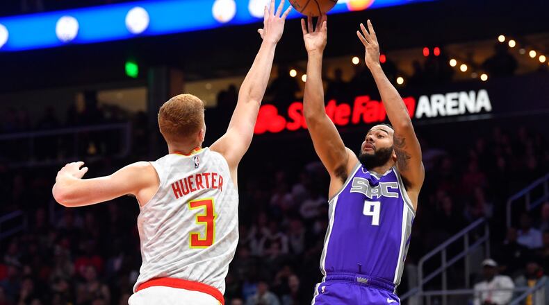 Sacramento Kings guard Cory Joseph (9) shoots as Atlanta Hawks guard Kevin Huerter (3) defends during the second half of an NBA basketball game Friday, Nov. 8, 2019, in Atlanta. The Kings won 121-109. (AP Photo/John Amis)