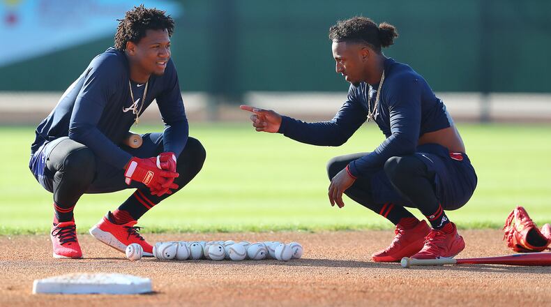Braves outfielder Ronald Acuna (left) and second baseman Ozzie Albies get in some work during spring training in February.