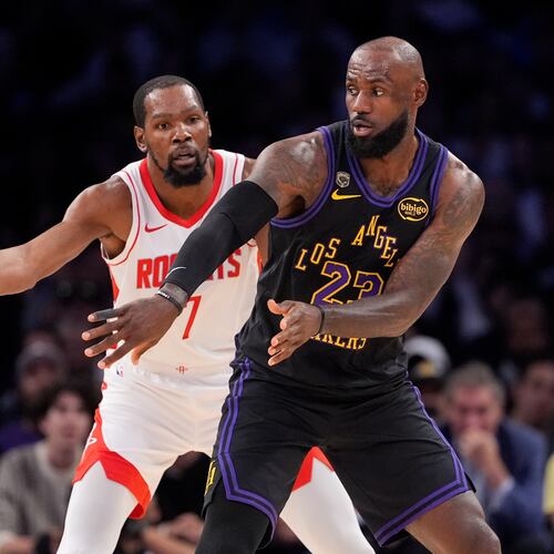 Los Angeles Lakers forward LeBron James, right, passes the ball while under pressure from Houston Rockets forward Kevin Durant during the first half in Game 2 of a first-round NBA playoffs basketball series Tuesday, April 21, 2026, in Los Angeles. (AP Photo/Mark J. Terrill)