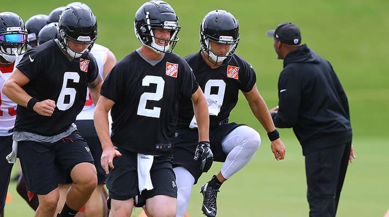 In a leap of faith exercise, Atlanta Falcons backup quarterback Matt Schaub lays on the ground becoming part of an agility drill while quarterbacks Matt Ryan, Kurt Benkert, Garrett Grayson and teammates step over him during the final day of mandatory minicamp Thursday, June 14, 2018, in Flowery Branch.